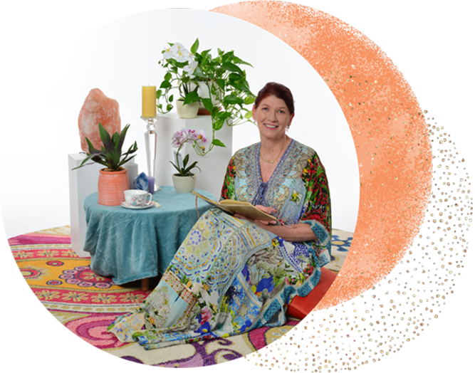 Leonie TRE Practitioner sitting infront of plants and salt lamp